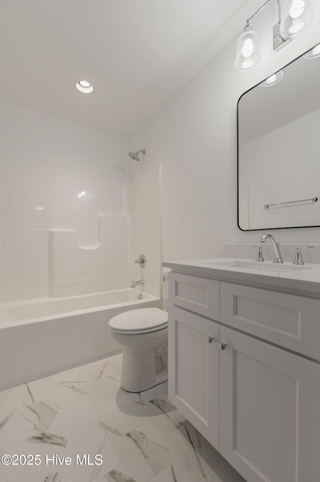 full bathroom with toilet, vanity, and shower / washtub combination