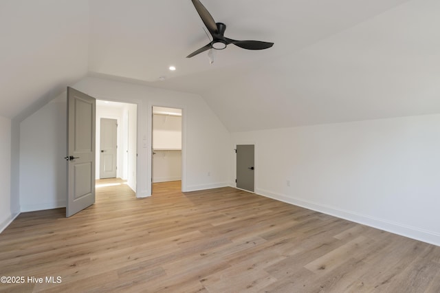 additional living space featuring vaulted ceiling, ceiling fan, and light hardwood / wood-style floors