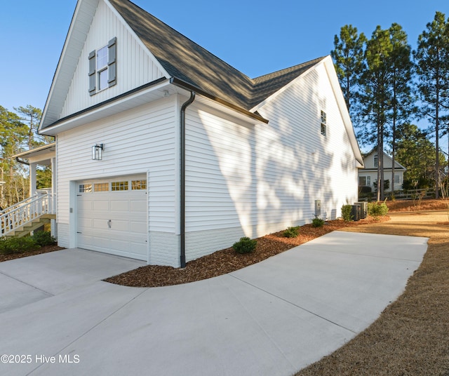 view of property exterior featuring a garage and central AC