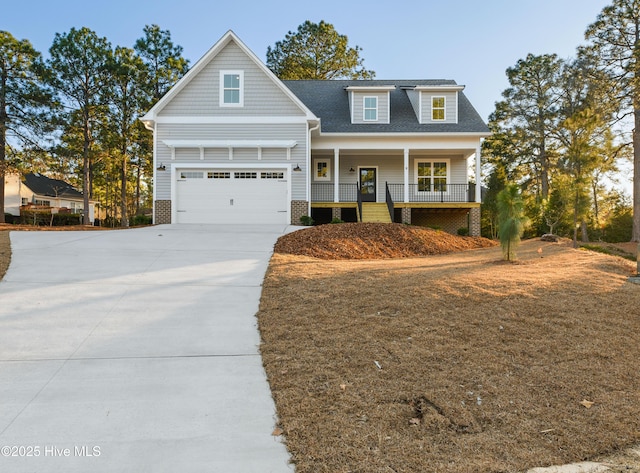 view of front of property with covered porch and a garage