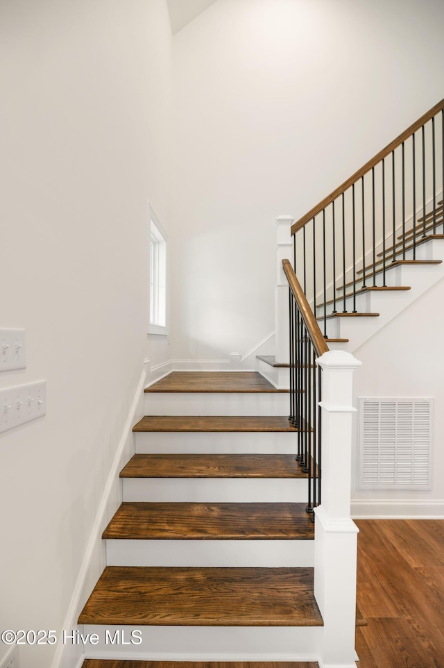 staircase with wood-type flooring