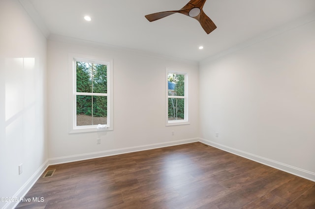 spare room with ceiling fan, dark wood-type flooring, and ornamental molding