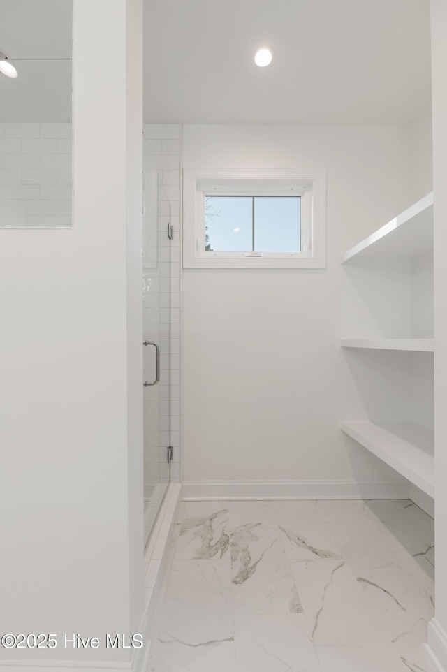 bathroom with a shower with door