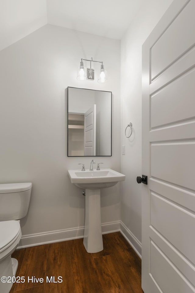 bathroom featuring sink, wood-type flooring, and toilet