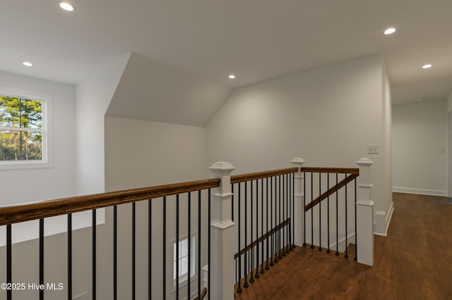 stairway with hardwood / wood-style flooring and vaulted ceiling