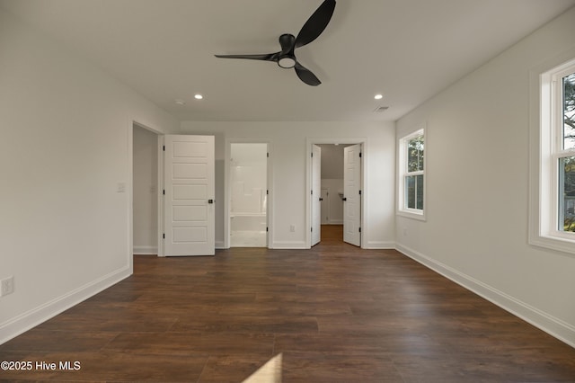 unfurnished bedroom with ceiling fan, ensuite bathroom, and dark hardwood / wood-style flooring