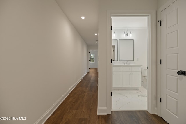 corridor featuring dark wood-type flooring and sink