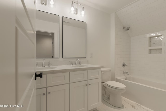 full bathroom featuring toilet, tiled shower / bath, and vanity