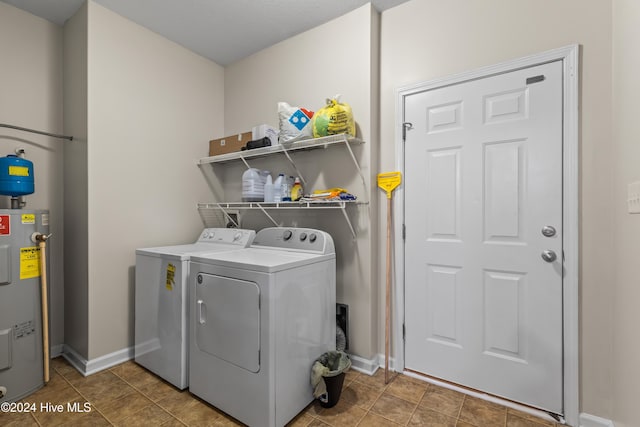 laundry room with water heater, tile patterned floors, and washing machine and dryer