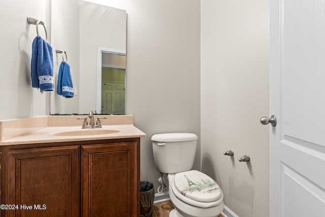 bathroom with toilet and vanity