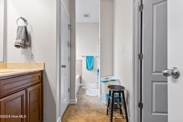 bathroom with tile patterned floors, vanity, and plus walk in shower