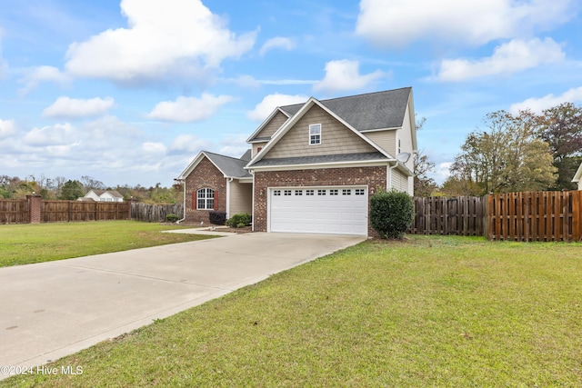 view of front of property featuring a front lawn and a garage