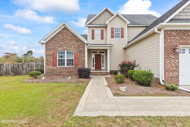 view of front of home featuring a front yard and a garage