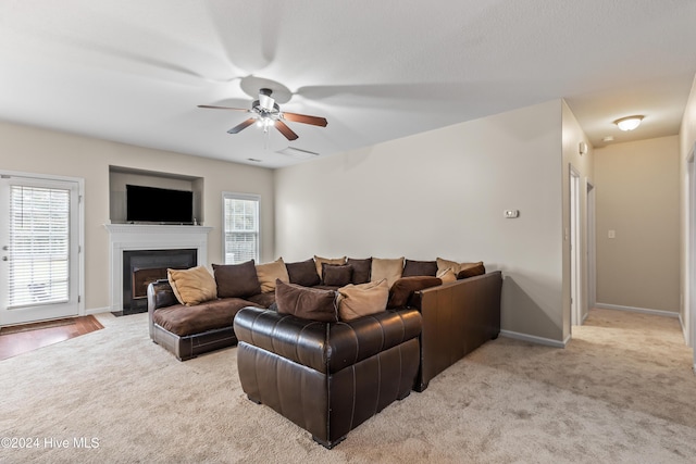 carpeted living room featuring ceiling fan