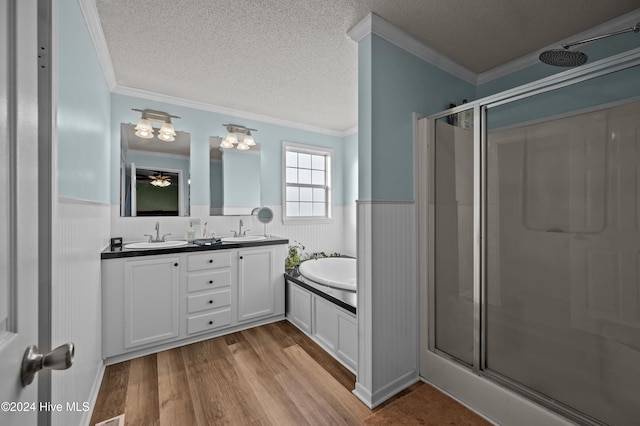 bathroom with ornamental molding, a textured ceiling, and hardwood / wood-style flooring