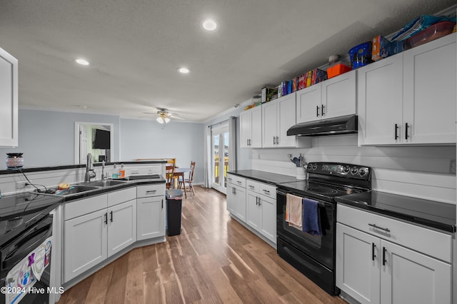 kitchen with ceiling fan, sink, hardwood / wood-style flooring, white cabinetry, and black / electric stove