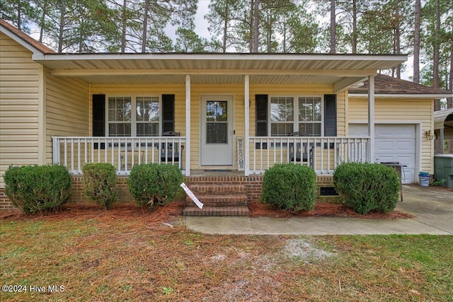 view of front facade with a porch and a garage