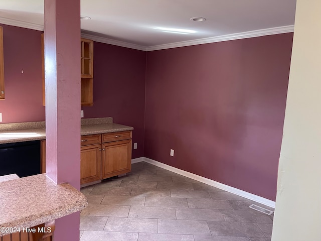 interior space featuring sink, light tile patterned flooring, and ornamental molding