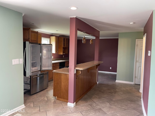 kitchen featuring a kitchen bar, pendant lighting, black dishwasher, and crown molding