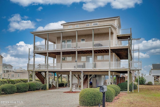 132 Reeves St, North Topsail Beach, NC 28460 - back of house with stairs, driveway, a carport, and a porch
