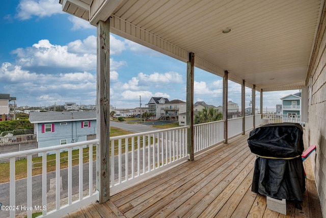 wooden deck featuring a grill