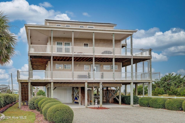 132 Reeves St, North Topsail Beach, NC 28460 - view of front of home with a carport, stairway, and gravel driveway