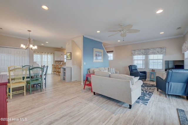 living room with crown molding, ceiling fan with notable chandelier, and light wood-type flooring