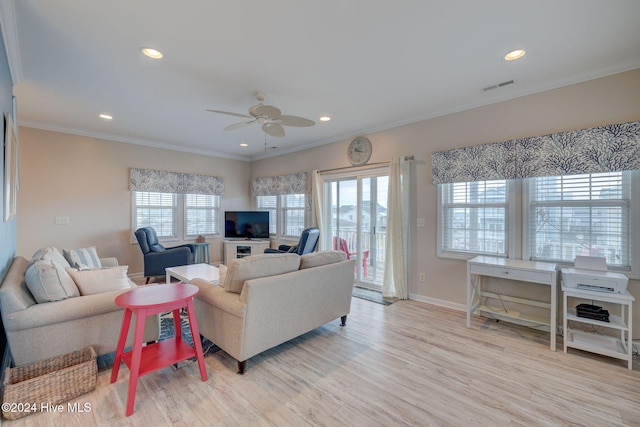 living room with ceiling fan, crown molding, and light hardwood / wood-style floors