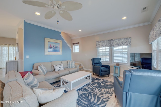 living room with hardwood / wood-style floors, a wealth of natural light, crown molding, and ceiling fan