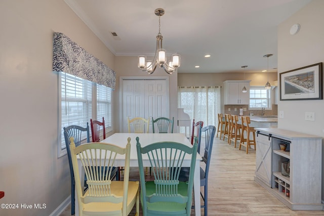 132 Reeves St, North Topsail Beach, NC 28460 - dining space featuring a chandelier, light wood-style flooring, ornamental molding, and recessed lighting