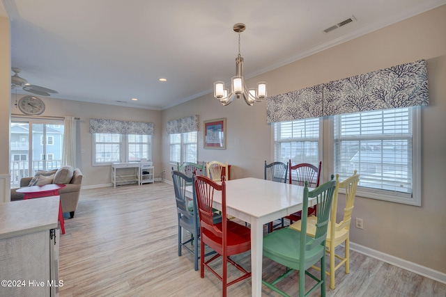 dining room featuring ceiling fan with notable chandelier, light wood-type flooring, and ornamental molding