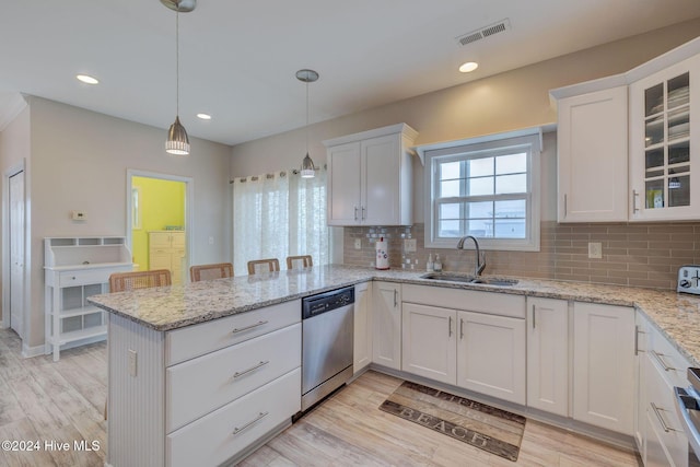 132 Reeves St, North Topsail Beach, NC 28460 - kitchen featuring dishwasher, a peninsula, white cabinets, light wood-style flooring, and recessed lighting