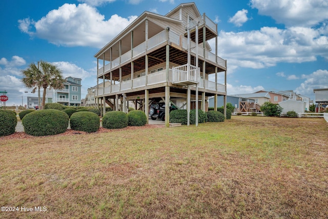 rear view of property featuring a lawn