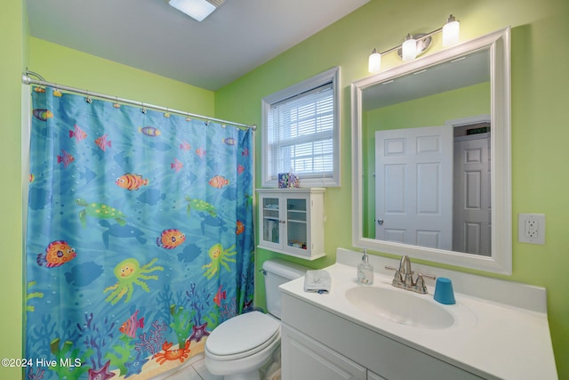 bathroom featuring a shower with shower curtain, vanity, toilet, and tile patterned flooring