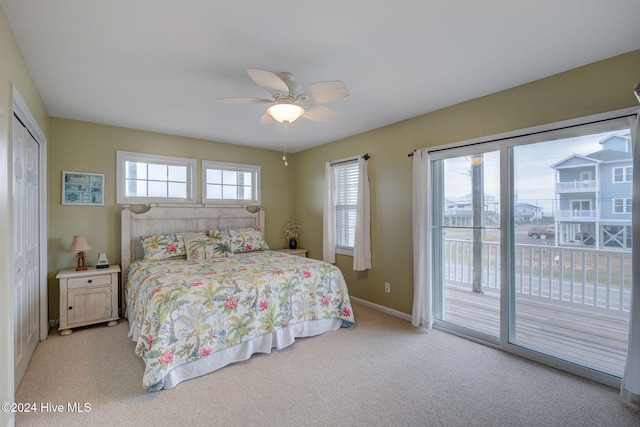 carpeted bedroom with ceiling fan, access to outside, and a closet