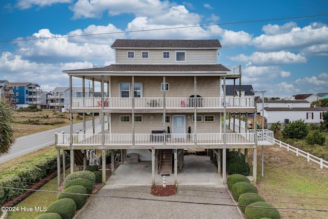 132 Reeves St, North Topsail Beach, NC 28460 - back of property with a carport, a balcony, driveway, and stairway