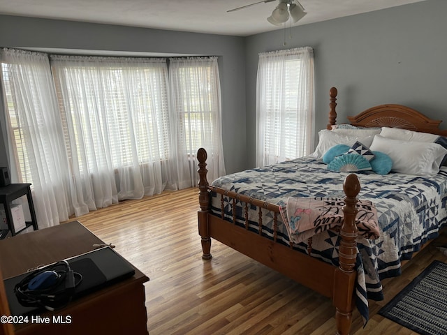 bedroom with ceiling fan and hardwood / wood-style flooring