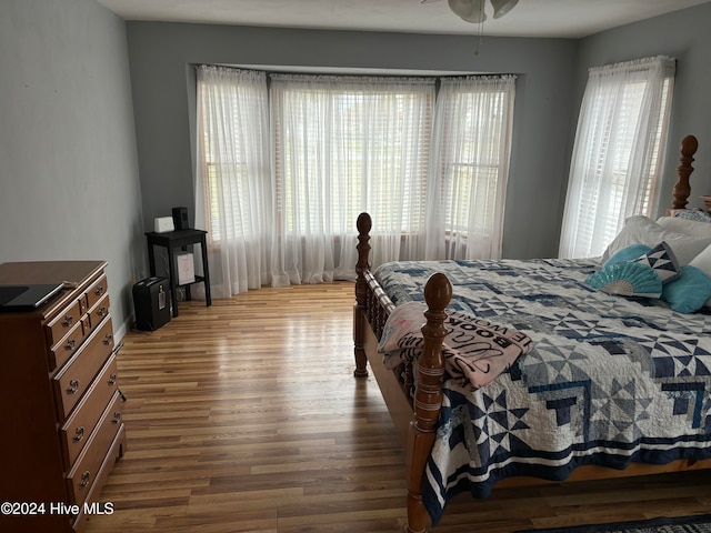 bedroom with wood-type flooring and multiple windows