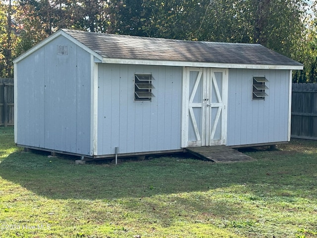 view of outbuilding featuring a lawn