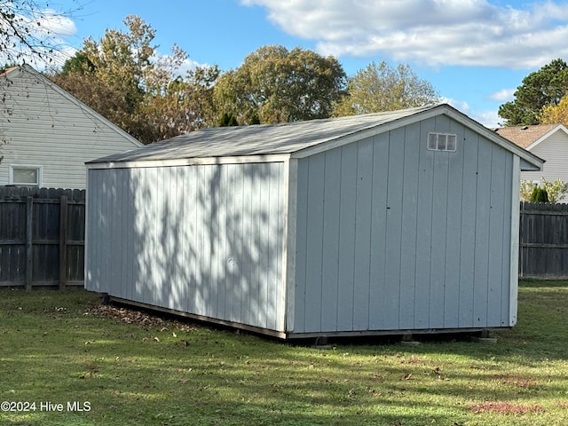 view of outbuilding featuring a lawn