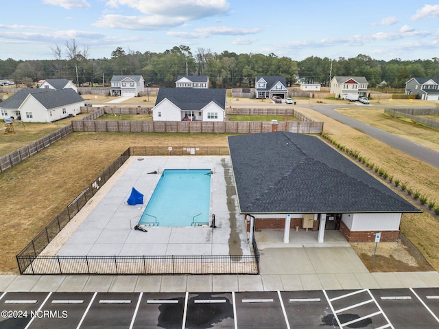 view of pool with a yard, a fenced in pool, a residential view, and a fenced backyard