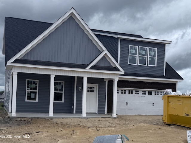 craftsman-style house with a porch, a garage, and roof with shingles