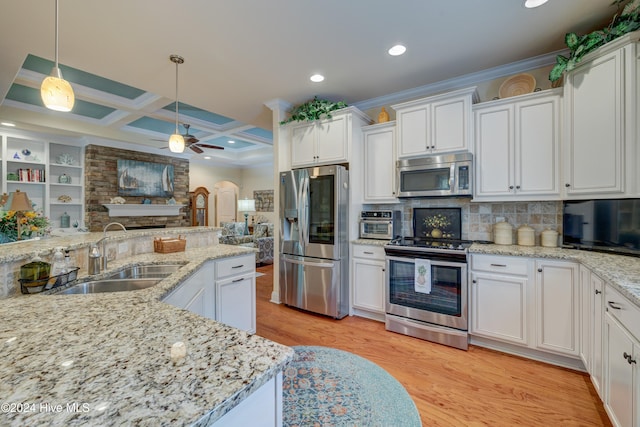 kitchen with stainless steel appliances, ceiling fan, sink, white cabinets, and light hardwood / wood-style floors