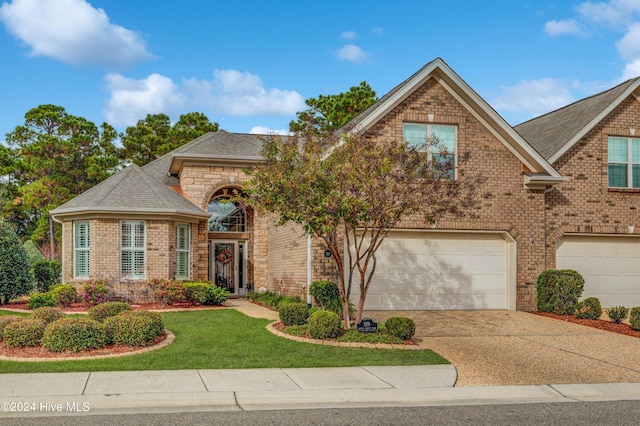 view of front of house featuring a garage and a front lawn