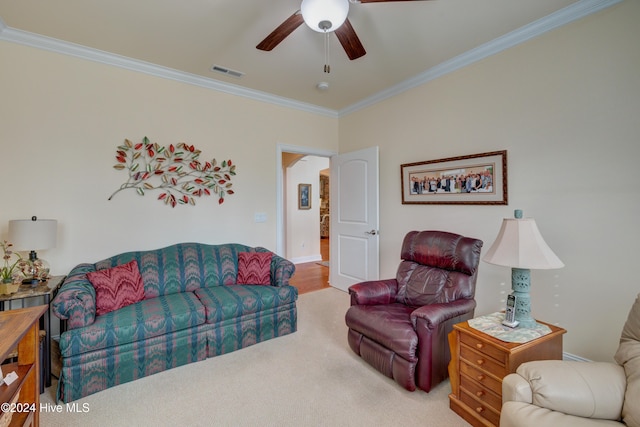 living room with ceiling fan, light hardwood / wood-style flooring, and ornamental molding