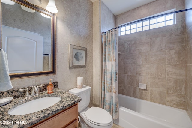 full bathroom featuring vanity, shower / bath combination with curtain, and toilet