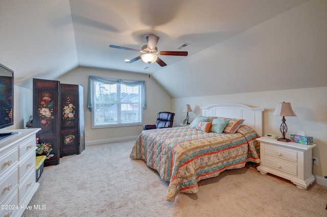 bedroom featuring light carpet, vaulted ceiling, and ceiling fan