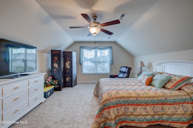 bedroom featuring ceiling fan, light colored carpet, and vaulted ceiling