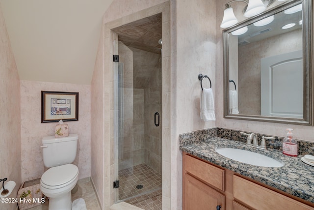 bathroom with vanity, toilet, and a shower with shower door