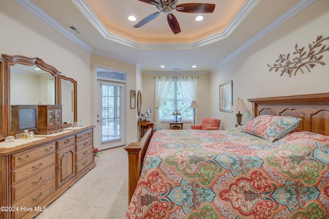 carpeted bedroom featuring a tray ceiling, access to exterior, crown molding, and ceiling fan